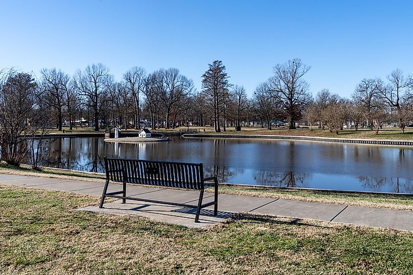 In the winter, Bob Noble Park in Paducah, Kentucky, features a tranquil scene with a bench overlooking a pond.