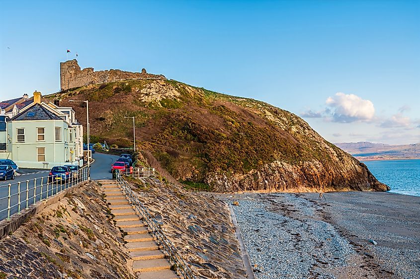 A view along the west beach towards the ruins of the castle above Criccieth, Wales in springtime