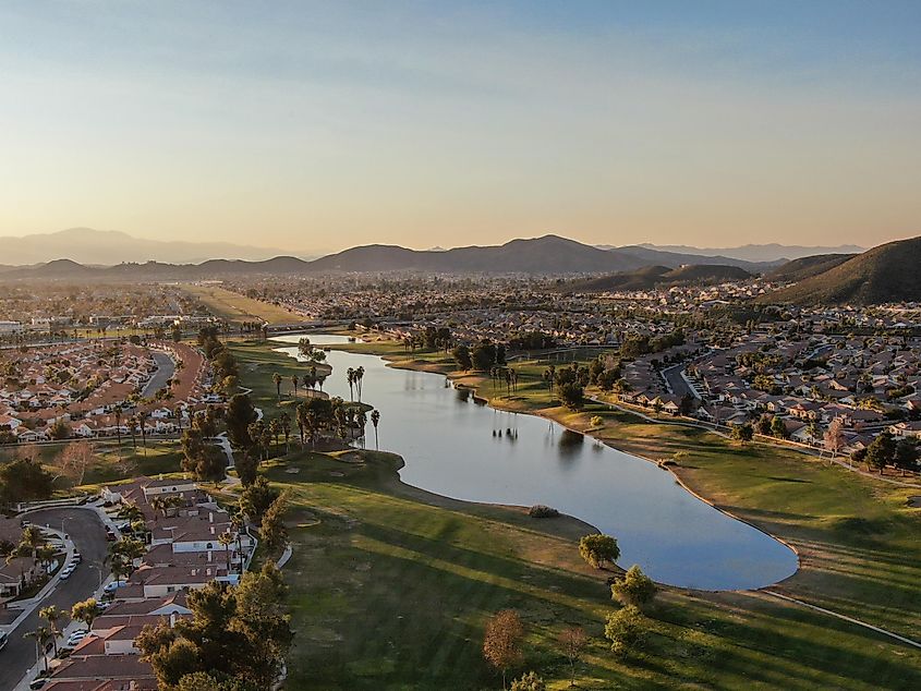 Aerial view of golf course surrounded by town houses and luxury villas during sunset time. Temecula, California,