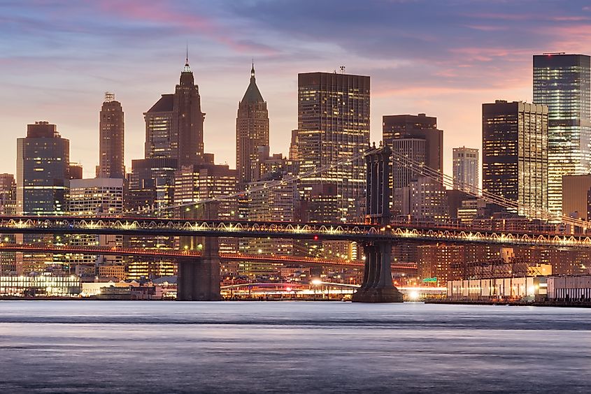 The New York, New York, USA downtown city skyline on the East River with both the Brooklyn Bridge and Manhattan Bridge. Via Shutterstock / Sean Pavone