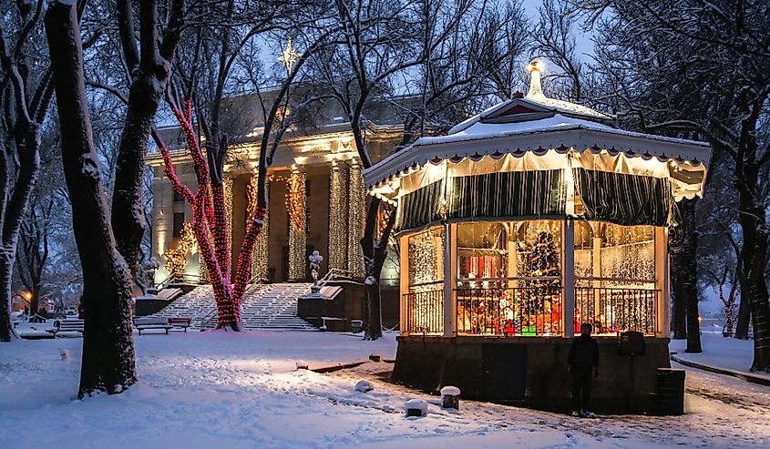 Holiday lights in the fresh snow around decorated gazebo at the Yavapai County Courthouse in Prescott, Arizona