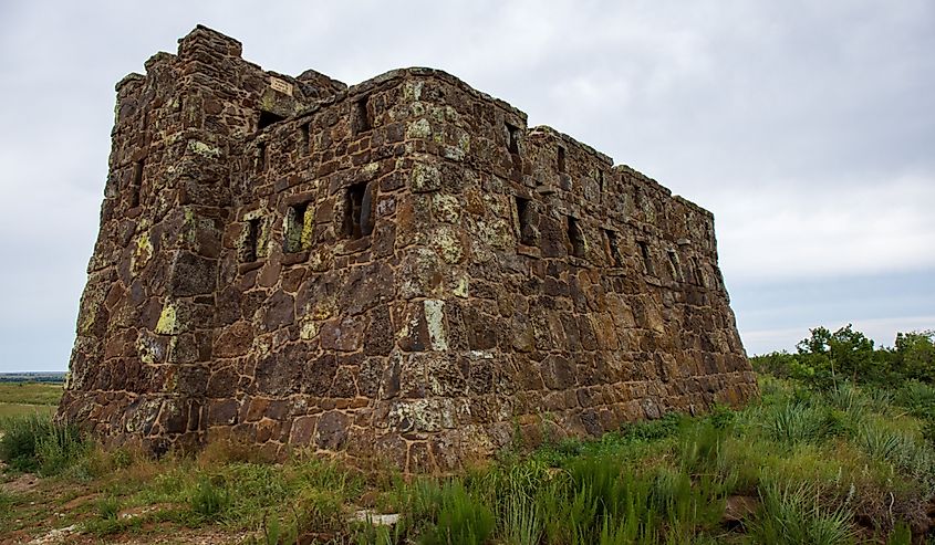  Stone castle on hilltop with muted sky background. Coronado Heights in Kansas countryside. 