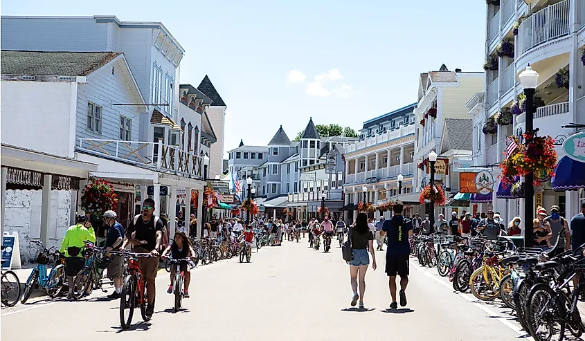 Visitors walking and bicycling along Main Street on Mackinac Island, Michigan.