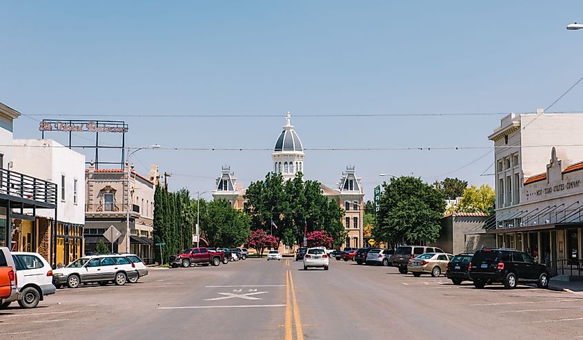 A view of the courthouse building in Marfa Texas during a bright summer day