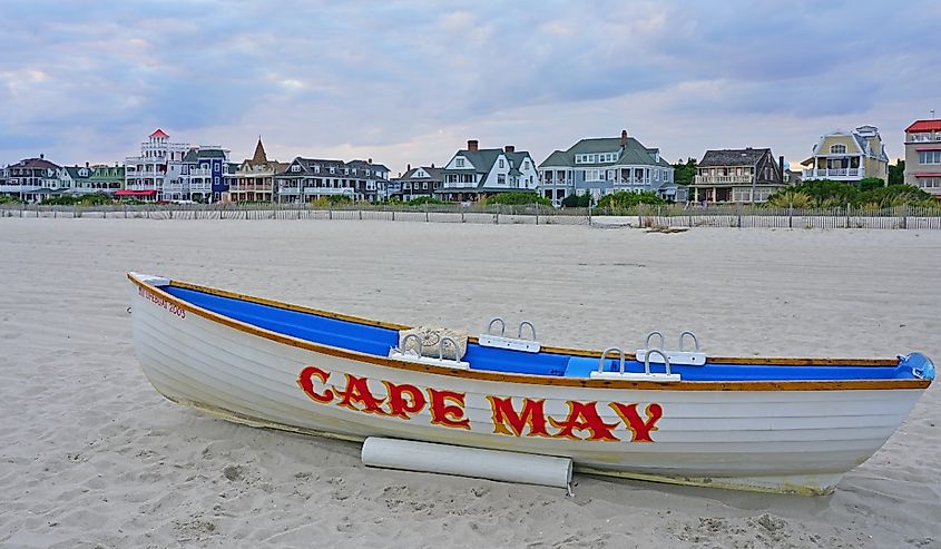 View of a boat with a Cape May sign on the beach in Cape May, New Jersey, USA.