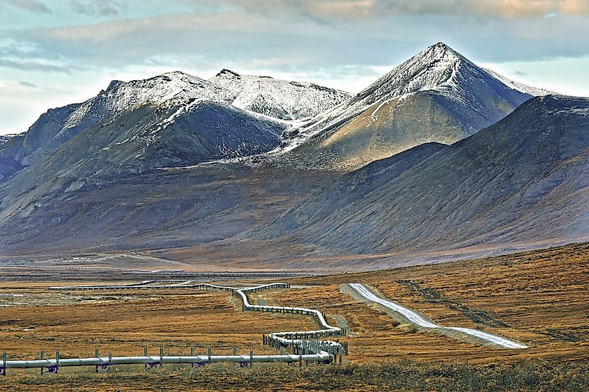The Trans-Alaska Pipeline running across the tundra beside the highway.