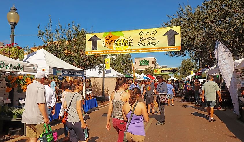 Vendors and shoppers at the Sarasota Farmers Market in fall.