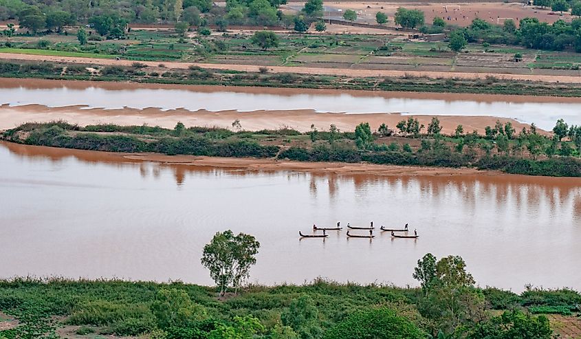 Nigerien fishermen fishing on their boats in Niger river during sunset in Niamey in Niger in Africa