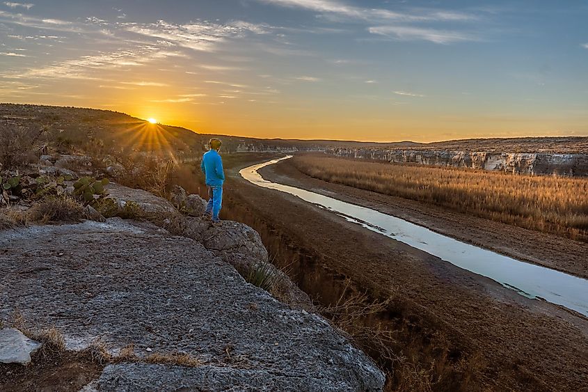 A hiker admiring the beauty of the Seminole Canyon State Park.