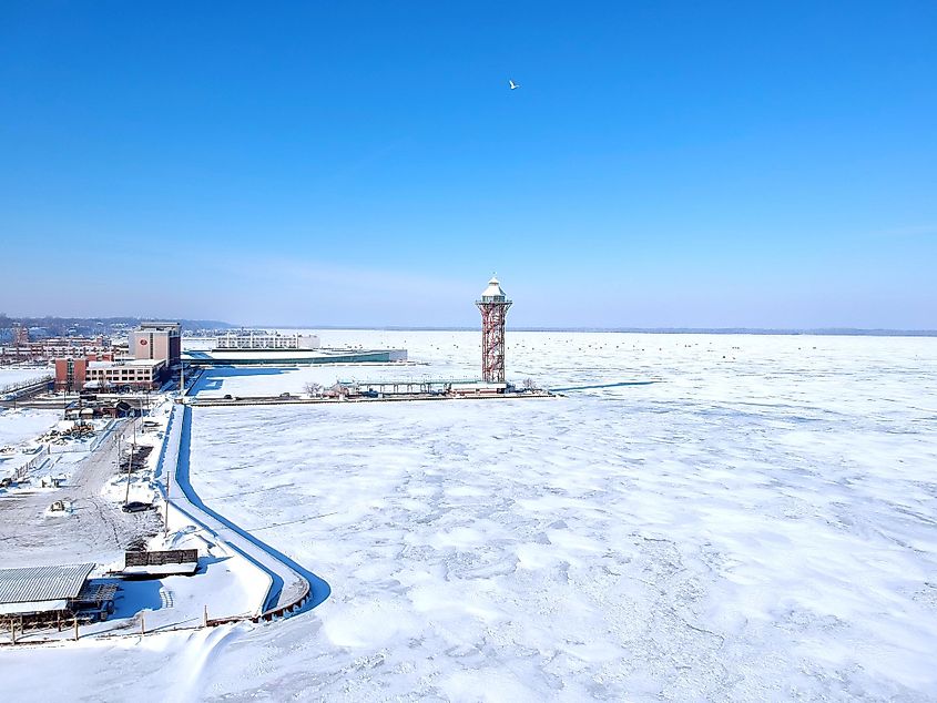 Aerial view of the city of Erie and the frozen Lake Erie in winter with ice fishing tents behind the Bicentennial Tower. Editorial credit: Carrie's Camera / Shutterstock.com