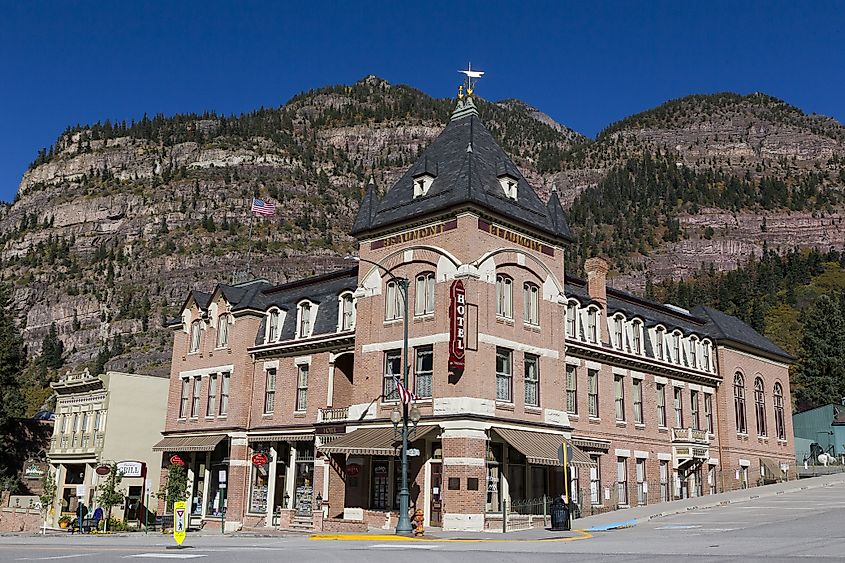 Beaumont Hotel on corner of Main Street with mountains in the background, Ouray, Colorado
