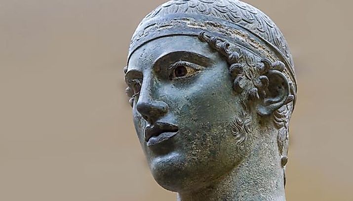 Close view of the head and face of the Charioteer, via the Archaeological Museum of Delphi