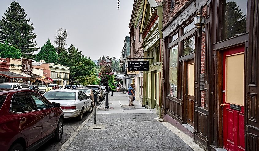 People spending time outside, walking this historic old town while smoke lingers in the air from the Carr fire, Nevada city, California