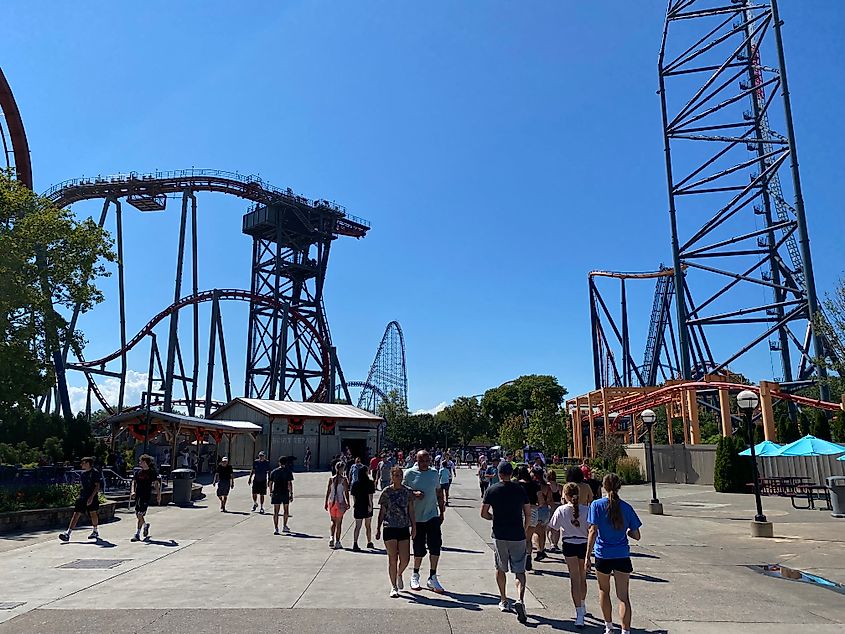 Crowds wandering between roller coasters at Ohio's Cedar Point amusement park.