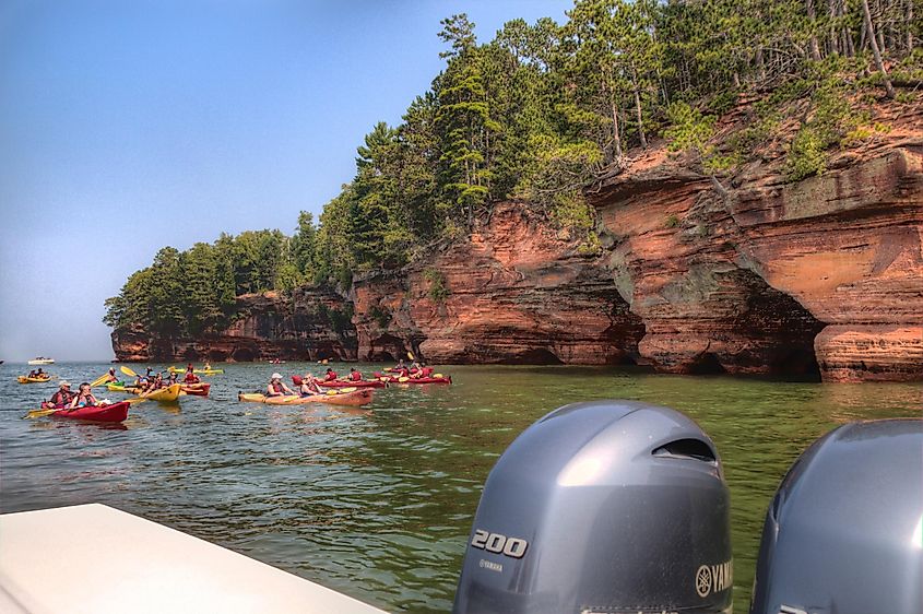 Kayakers enjoy the Apostle Island National Sea Caves, via Jacob Boomsma / Shutterstock.com