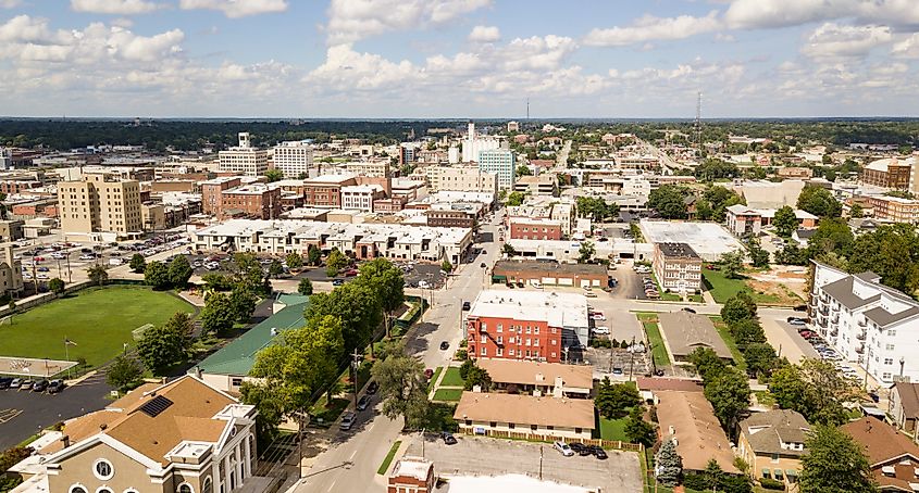 The downtown city skyline and buidlings of Sprigfield MO under partly cloudy skies aerial perspective