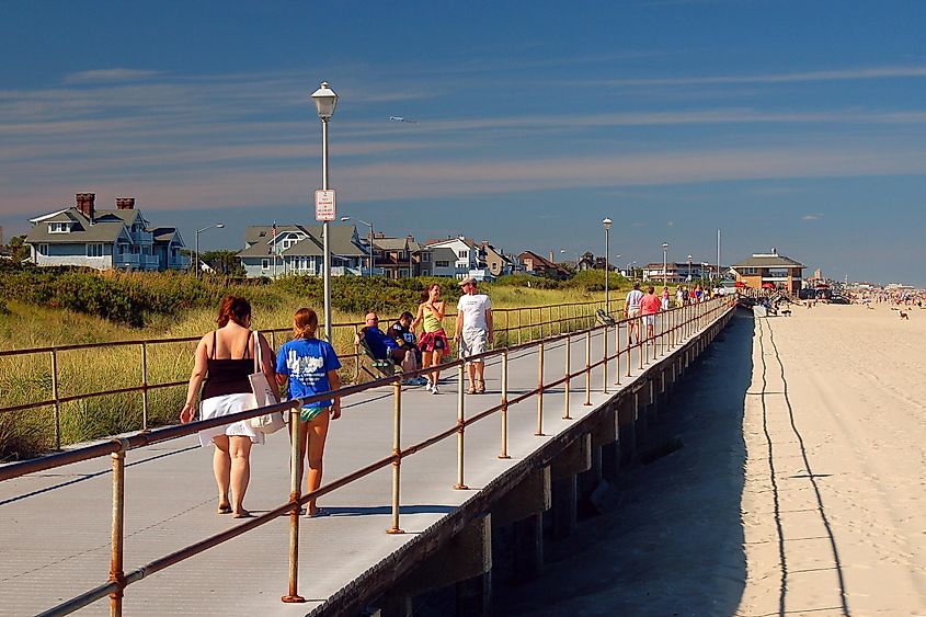Folks enjoy a summer's day strolling on the boardwalk in Spring Lake, New Jersey, USA.