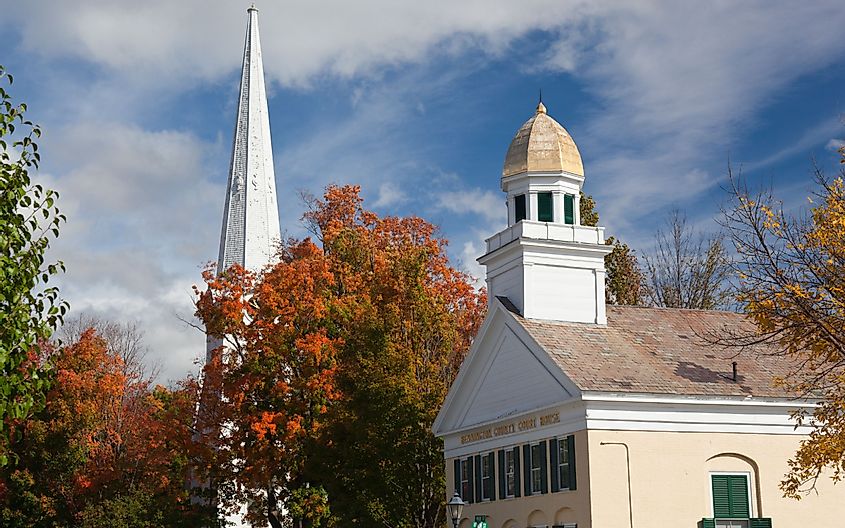 shot of the main street of Manchester Vermont in fall as the bright trees turn orange and red
