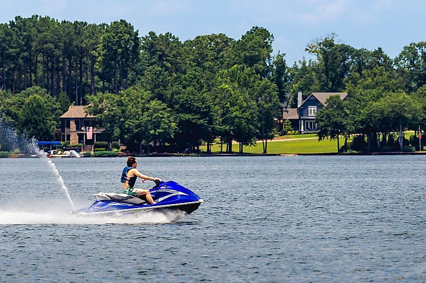 Man riding jet ski and enjoying summer day on Lake Oconee in Greensboro, Georgia.