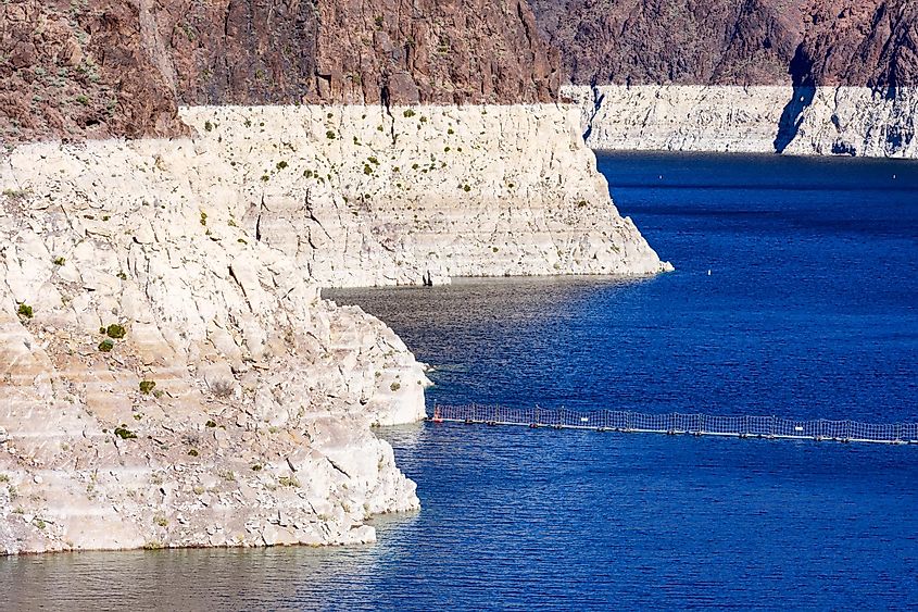 Record low water level of shrinking Lake Mead exposed white surface on rocky banks amid severe drought in American West.
