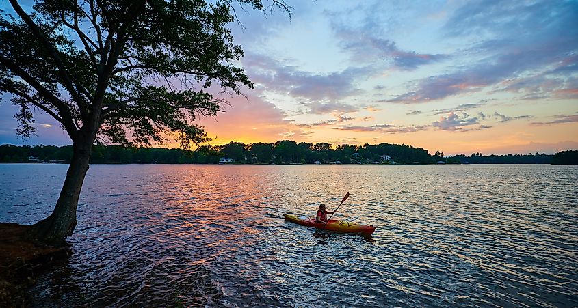 A kayaker on Lake Keowee at sunset