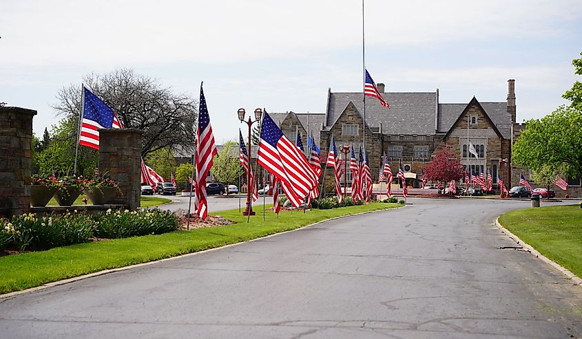American flags waving at wisconsin memorial park cemetery to honor and celebrate fallen soldiers and veterans of united states wars for usa memorial day in Brookfield, Wisconsin 