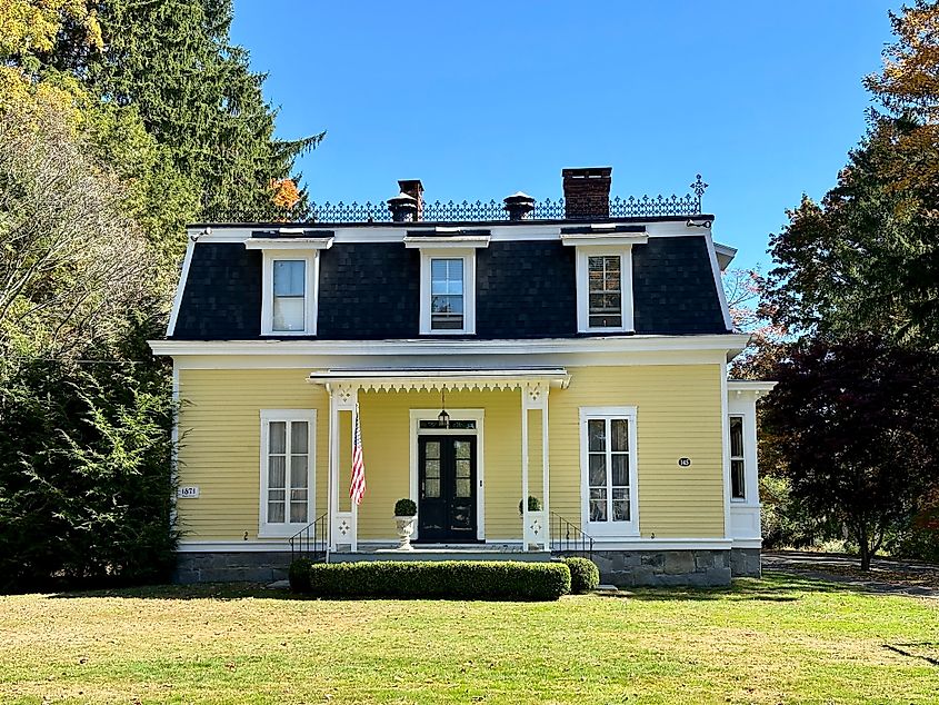 Litchfield, Connecticut, USA - October 6, 2024: Two-story, Second Empire house. Yellow, vintage home in historic district, built in 1871.