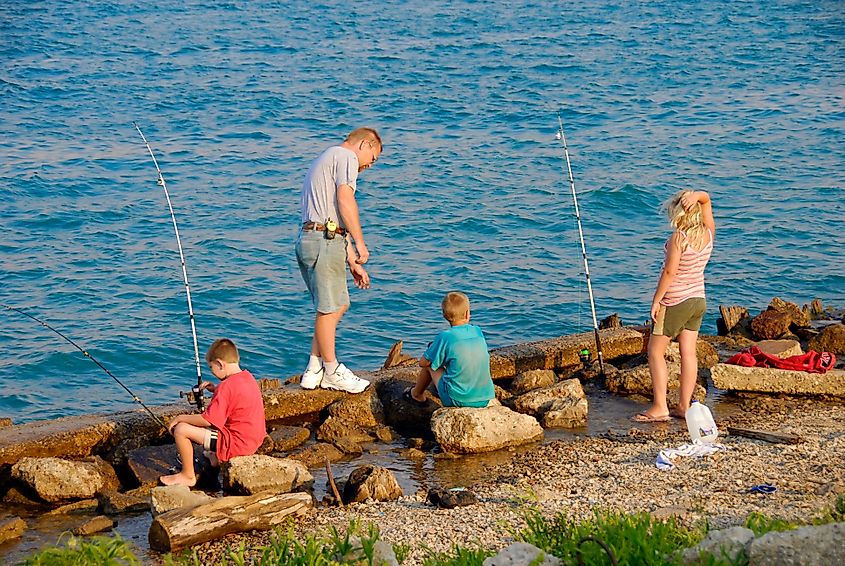 Family having fun fishing on a warm summer day in the Maumee River at Toledo Ohio. Editorial credit: Dennis MacDonald / Shutterstock.com
