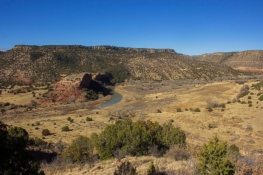 Mills Canyon with the Canadian River winding past a prominent rock formation in Kiowa National Grassland, Roy, New Mexico.