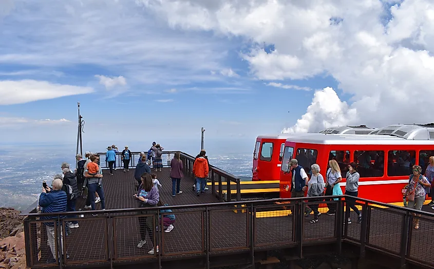 A red train of the Broadmoor Manitou and Pikes Peak Cog Railway at the summit terminal station next to the visitor center. Editorial credit: SJsWildPhotos / Shutterstock.com