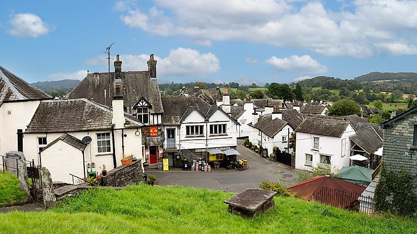 Shops and tourist pubs and cafe in the centre of Hawkshead village in the English Lake District National Park (Editorial credit: Clare Louise Jackson / Shutterstock.com)