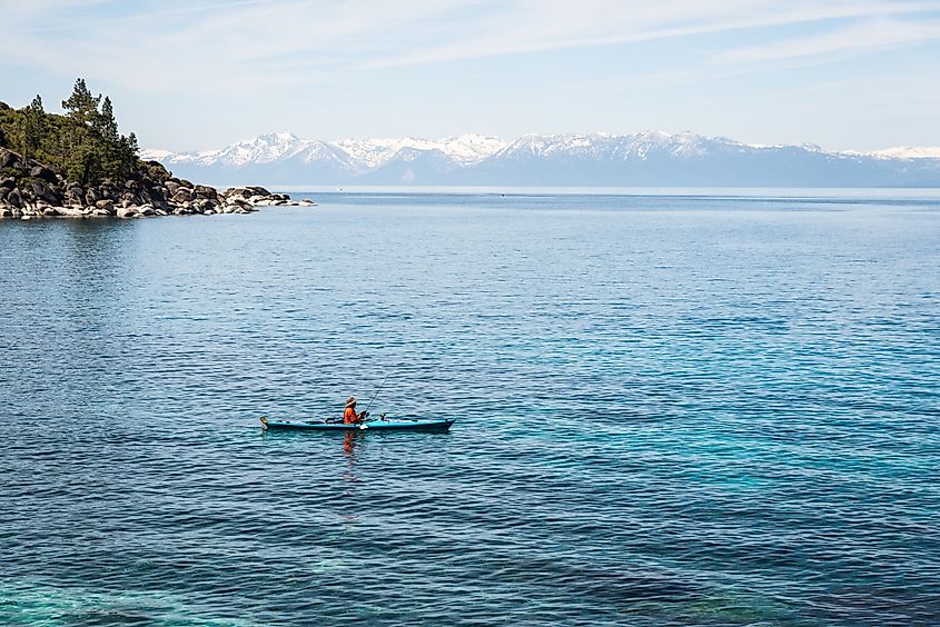 Man fishing from kayak at Lake Tahoe.
