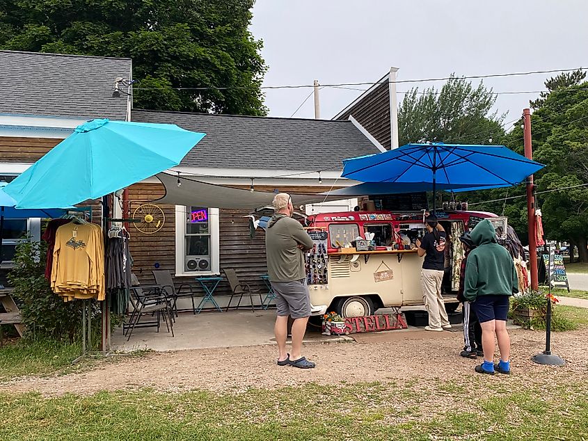 Customers queue for coffee outside of a little hippie van kitchen.