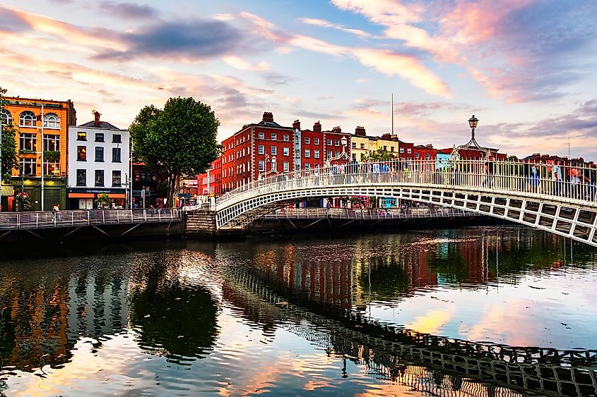 Dublin, Ireland. Night view of famous illuminated Ha Penny Bridge in Dublin, Ireland at sunset