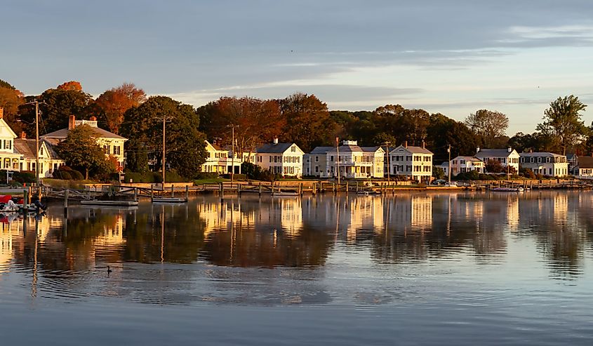 Panoramic view of residential homes by the Mystic River during a vibrant sunrise. 