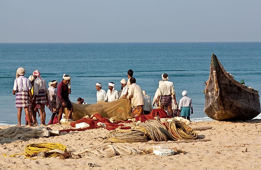 Fishermen get their fishing nets ready to go fishing in the Lakshadweep Sea.