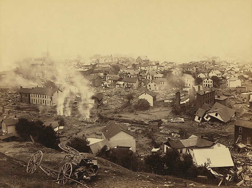 General view of Johnstown from high ground after the flood of May 31st, 1889. Horse drawn wagons and men work in the central mid-ground, possibly recovering bodies Editorial credit: Everett Collection / Shutterstock.com 