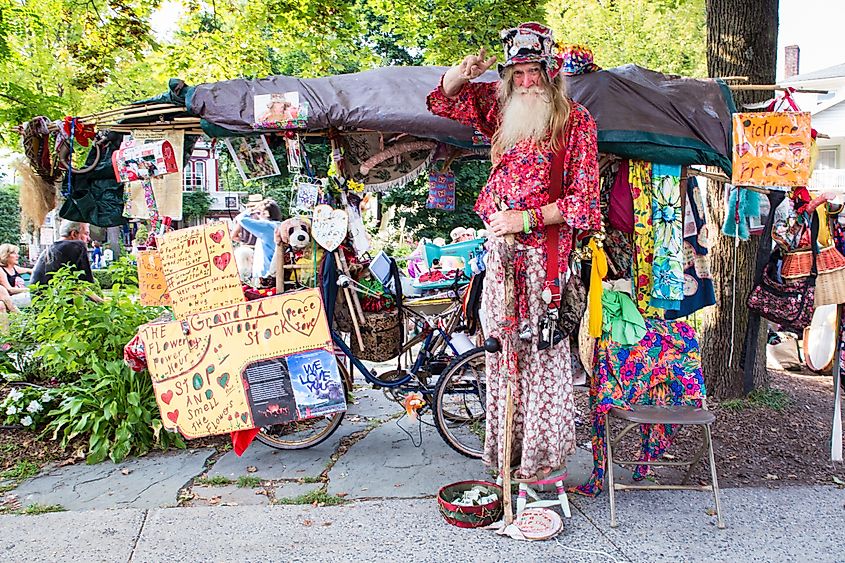 Grandpa Woodstock, poses for photograph outside tent sale in Woodstock New York.