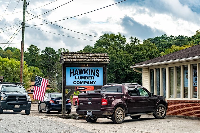 Marion, North Carolina: A sign for Hawkins Lumber Company business store shop and American Flag
