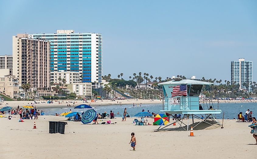 People enjoy a sunny day on the beach at Long Beach, California.