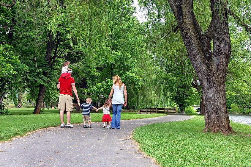  A family of five walks down a curving path at the Elizabethton Covered Bridge in Elizabethton, Tennessee.