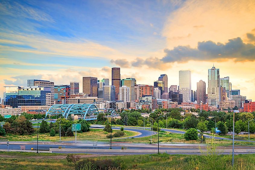 The downtown skyline of Denver, Colorado, with the Rocky Mountains behind.