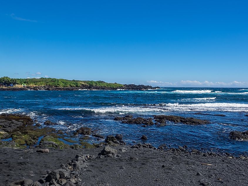 Punaluu Beach has black sand created by lava flowing into the ocean which explodes as it reaches the ocean and cools.