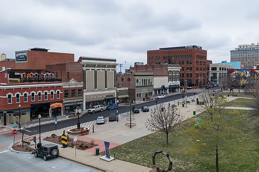 Felix Street Square in downtown St. Joseph. View of cars parked, sculptures, and local business in the background, via APN Photography / Shutterstock.com