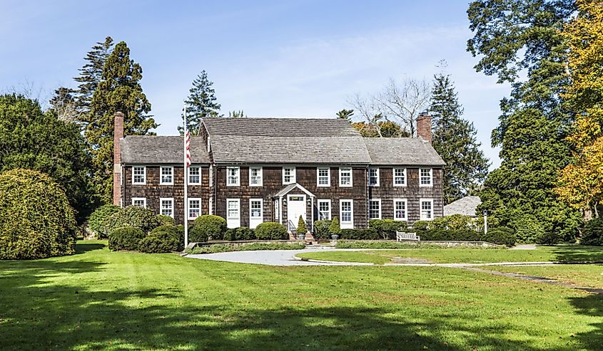 View of an old Victorian buildings and the public park in East Hampton on a sunny day.