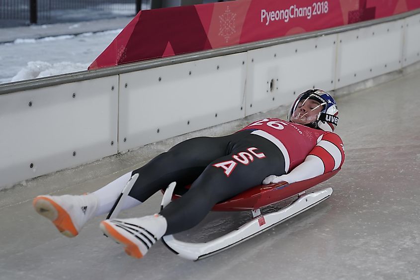 A luge athlete speeding down an icy track.