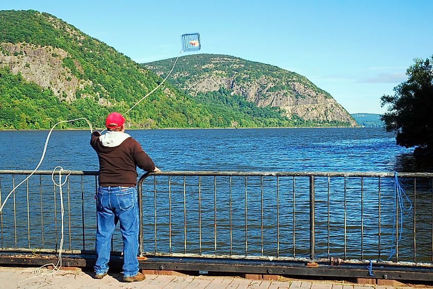 A man casts a crab trap into the Hudson River