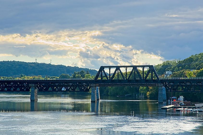 Railroad bridge over Merrimack river under cloudscape in Haverhill Massachusetts.