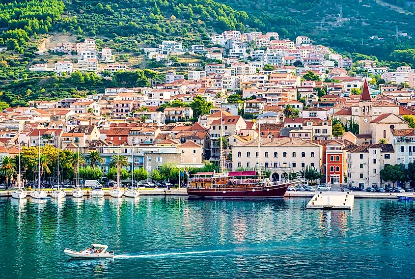 Panoramic view of Makarska, Croatia, with the harbor, boats, and blue Adriatic Sea along the Dalmatian coast.