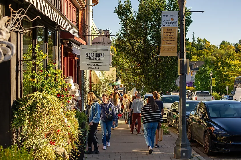 People stroll through the charming streets of Elora, Ontario. 